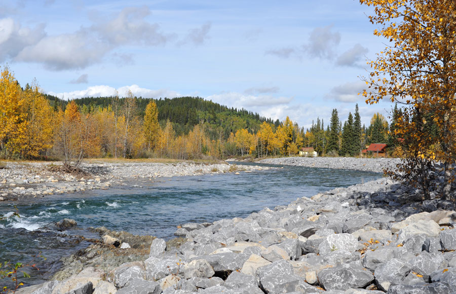 Bragg Creek, Alberta with Elbow River near homes suitable for blinds, shades and other window coverings.